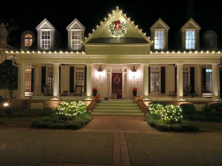 Christmas lights on every roof edge with the entry framed