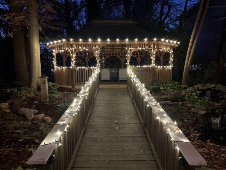 Lit walkway leading to a lit roofline