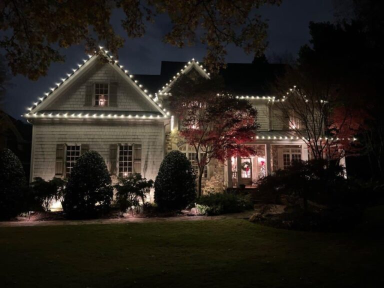 About Light The Peak's work: warm white lights tracing a two-story roofline