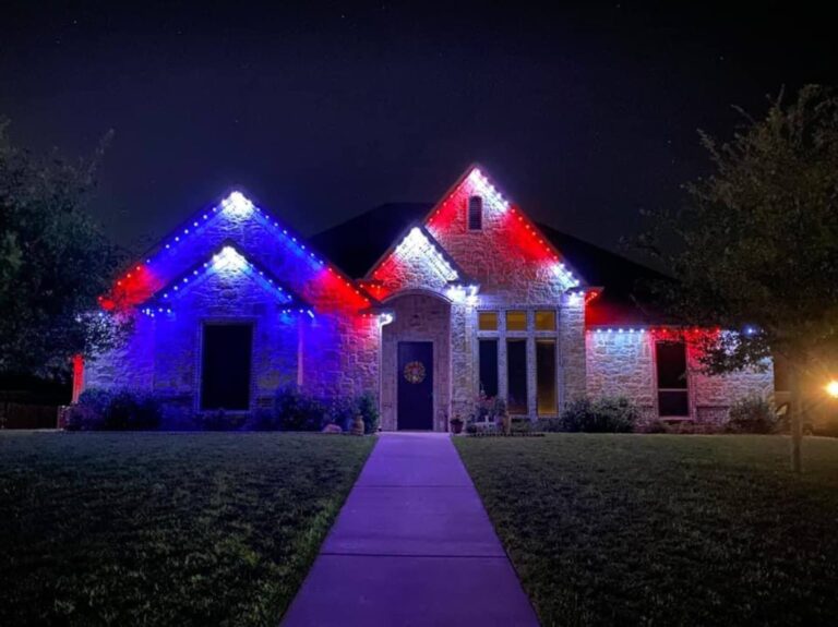 Red, white and blue permanent lights on the rooflines of a single-story home