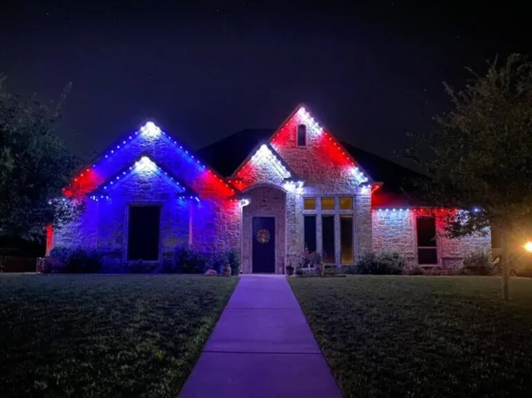 Red, white and blue permanent lights on the rooflines of a single-story home