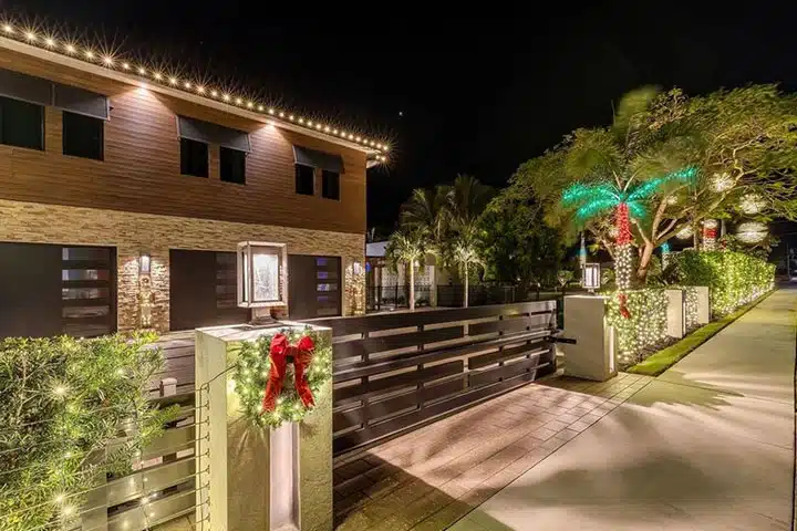 Central Florida Christmas light installation on modern home with palm tree lighting