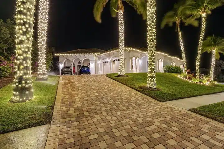 Professional Christmas light installation Orlando home with wrapped palm trees