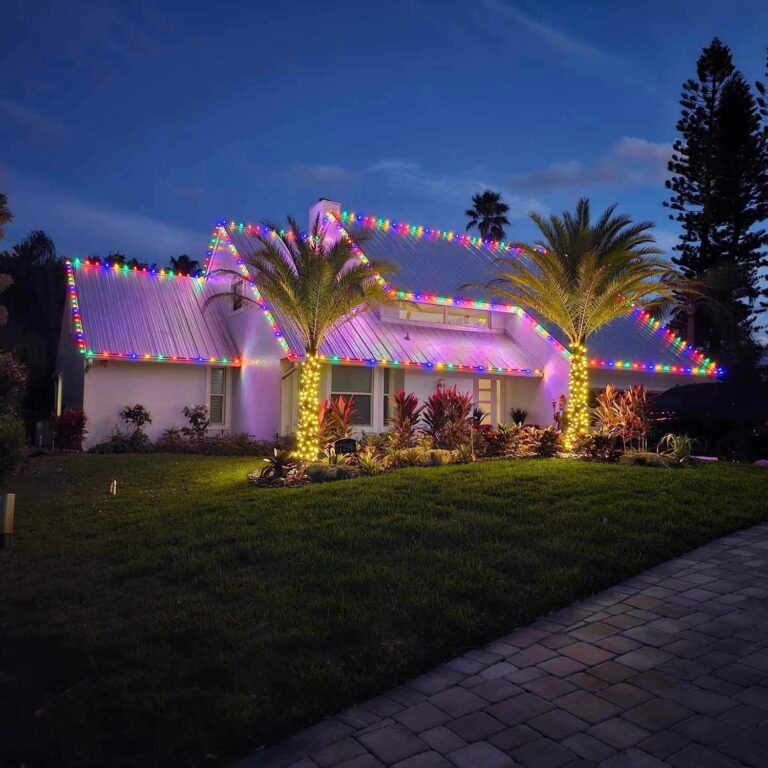 Multicolor Christmas lights on a metal roof with wrapped palm trees