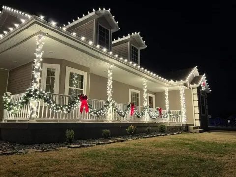 Christmas light installation on a wraparound porch, the same work we do in Clermont